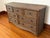 Skirted bow front dresser fully wrapped in woven rattan. It has seven drawers; three smaller drawers run across the top,...