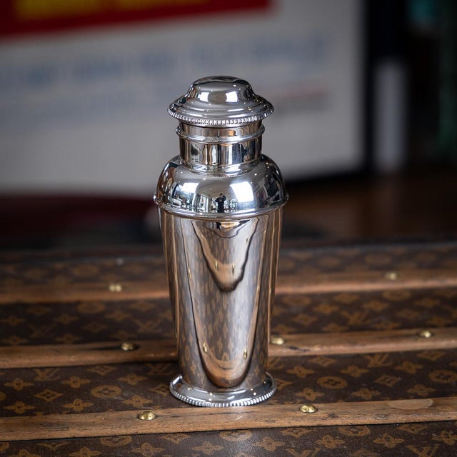 A vintage 20th century english solid silver art deco cocktail shaker, of tapering cylindrical form, rising from a stepped...