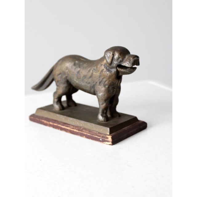 Antique brass nutcracker modeled in the form of a dog, sculptural in presence with a warm, timeworn character. Cast in...