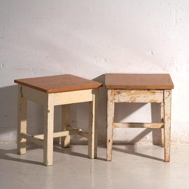 A pair of antique bedside tables in pine wood, with a square top and four tapered legs tied by box stretchers. They...