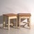 A pair of antique bedside tables in pine wood, with a square top and four tapered legs tied by box stretchers. They...