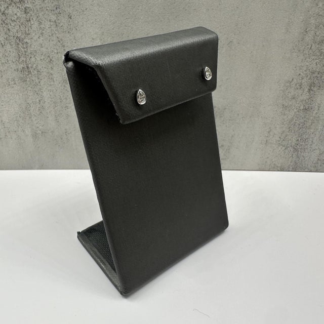 Add a touch of elegance and modern sophistication to your style with these Bezel Set Pear Cut Diamond Studs, crafted in...