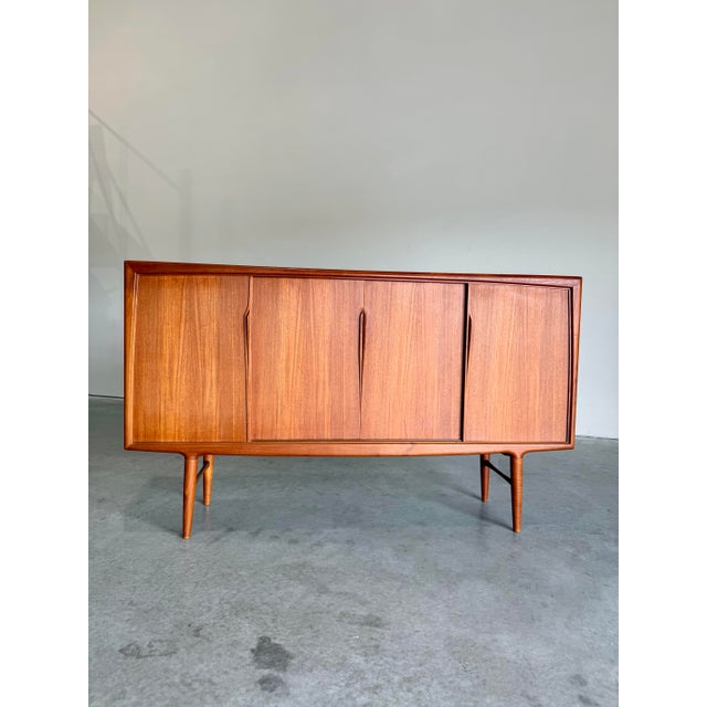 Mid Century Modern Danish Teak Highboard Cabinet designed attrb to Gunni Omann for Omann Jun. Features four sliding doors...