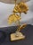 An elegant and highly decorative pair of gilt bronze table lamps modeled as gracefully intertwining ginkgo branches with...