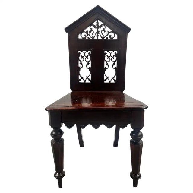 Antique English Gothic Revival Carved Oak Hall Chair with Pierced Tracery Back A striking antique English Gothic Revival...