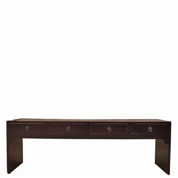 This low, simple wooden console table features four side-by-side drawers built into the front, each with a simple metal...