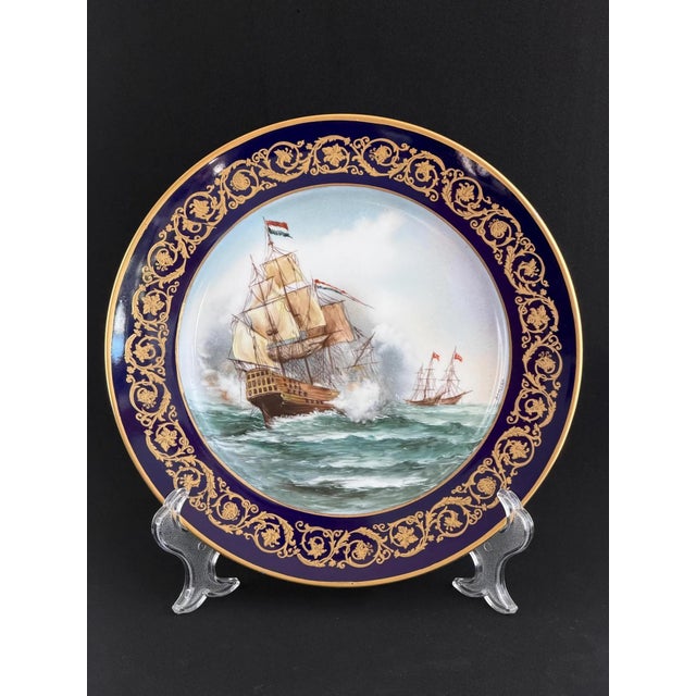 Exceptional pair of large hand-painted display plates in Sèvres-style, each featuring a dramatic 18th-century naval battle...
