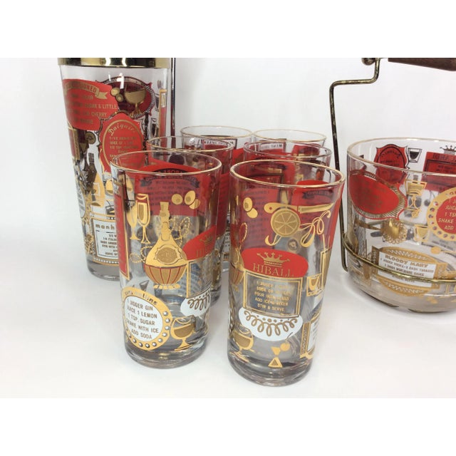 Mid-Century Recipe Cocktail Set consisting of a shaker, an ice bucket and 6 highball glasses. Each decorated in deep red...