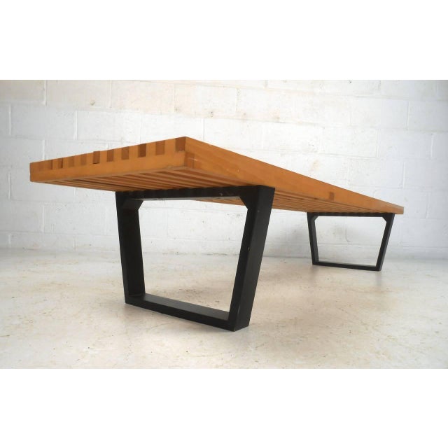 This long late 20th century Nelson style bench makes a stylish addition to any room as bench or coffee table. Sturdy...