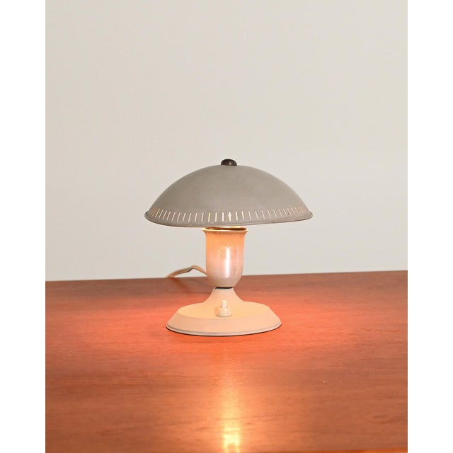 Painted metal frame with adjustable lampshade, satin-finish aluminum body, and circular base. Sae brand and "77" model...