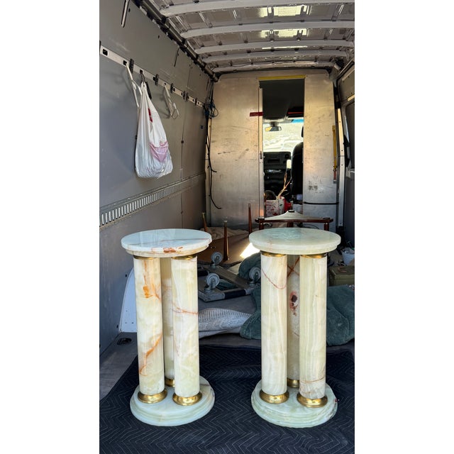 These Mid-Century Modern Onyx Triple Cylinder Base Side Tables stand at a height of 27 inches, featuring a sleek and...