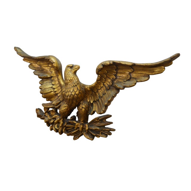A very large mid century Hollywood Regency golden heraldic eagle wall hanging plaque. Made of a resin composition...