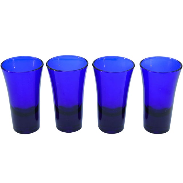 Set of four midcentury crystal shot glasses in cobalt blue with ornate details. No maker's mark. This beautiful set ships...