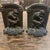 An Art Deco set of cast iron bookends featuring a unique Rodin "The Thinker" inspired design.