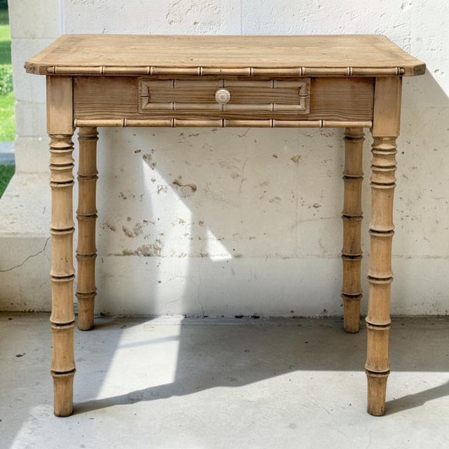 A delightful French 19th century table crafted from stripped pine and richly detailed with carved faux bamboo. The bamboo...