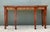 This grand Neoclassical breakfront console table is a masterclass in architectural elegance and traditional...