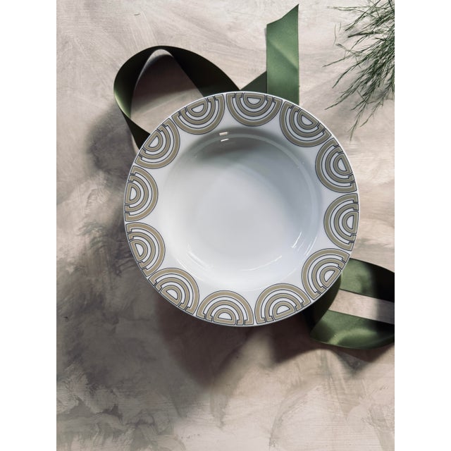 Set of eight Fitz and Floyd, 1976, soup bowls in the pattern called the Ritz. A looping taupe pattern outlined in a thin...