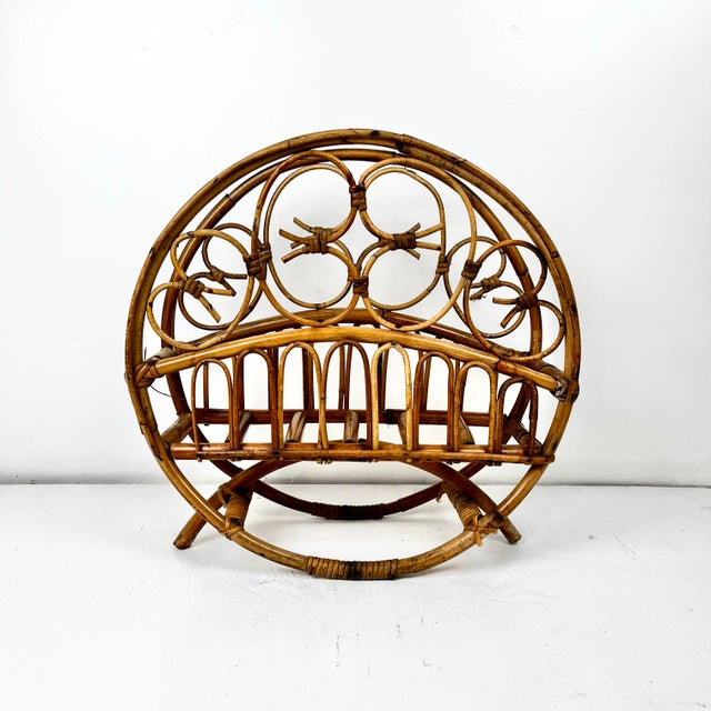 Mid century burnt bamboo rattan magazine rack. Round bamboo frame with pencil reed rattan fretwork. Arched bamboo legs.