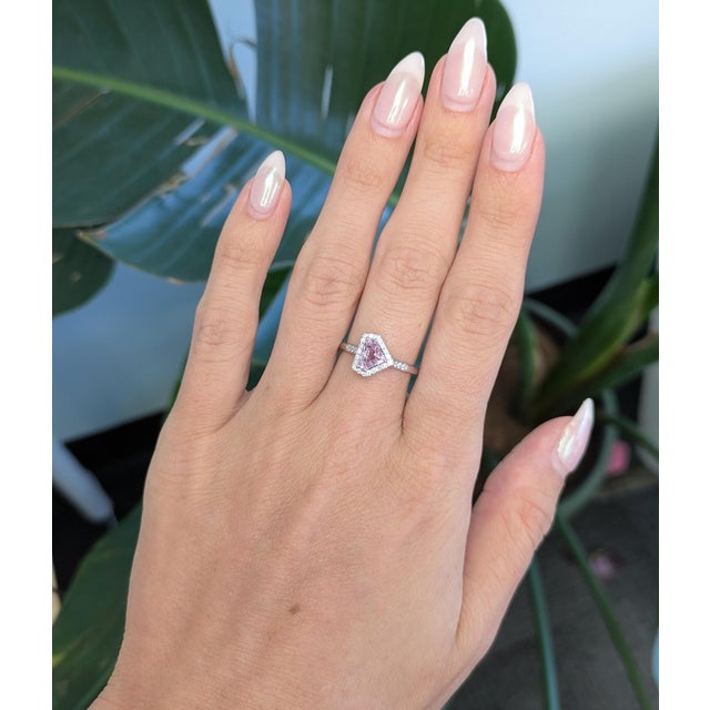 Elegant pink sapphire ring accented with earth-mined diamonds, crafted in solid 14K gold for a timeless, luxurious appeal....