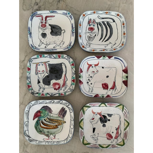 Great set of six whimsical hand-painted plates featuring cows, a rooster, a cat, and a rabbit, all signed by the...
