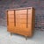 A distinctive mid-century modern walnut highboy dresser by Johnson Carper, dating to approximately the 1960s. The dresser...