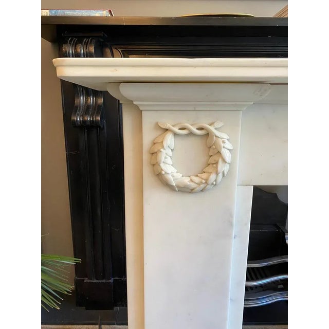 An elegantly simple english early 19th century statuary white marble fireplace, the plain pilaster jambs adorned with...
