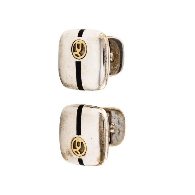 Estate cufflinks by David Yurman crafted in 18K gold and sterling silver featuring the iconic David Yurman enamel logo...