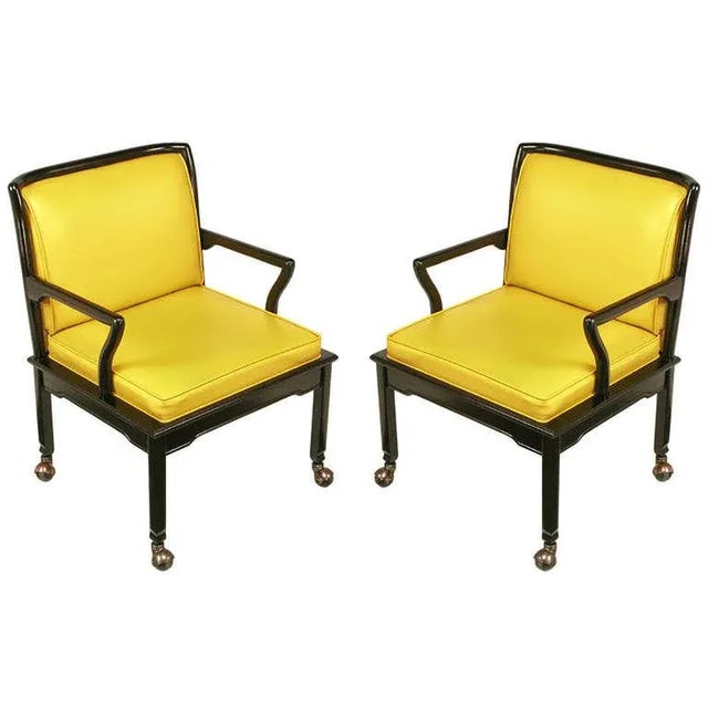 Pair of Widdicomb ebonized mahogany and saffron leather-like upholstered chinoiserie lounge chairs. Good sized seats with...