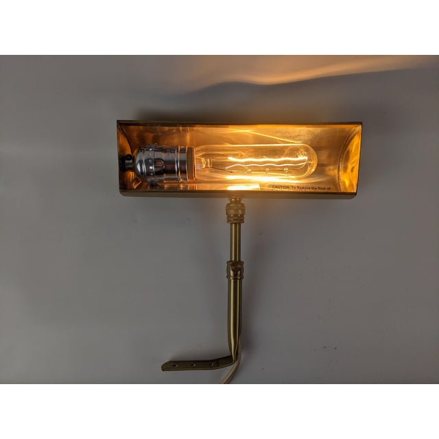 Classic House of Troy fine-art picture light in a warm antique/brushed brass finish, designed to provide focused...