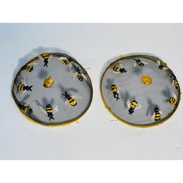 Vintage pair of insect food covers of metal net decorated with handmade bees.