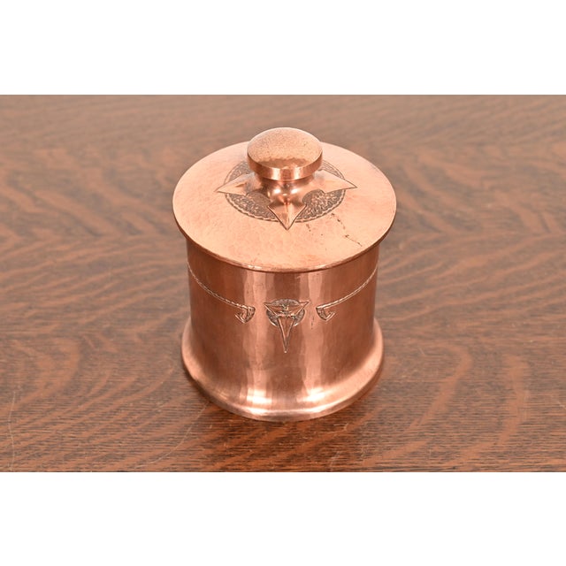 A gorgeous Arts & Crafts period trefoil hammered copper humidor By Roycroft (signed with impressed orb and cross mark)...