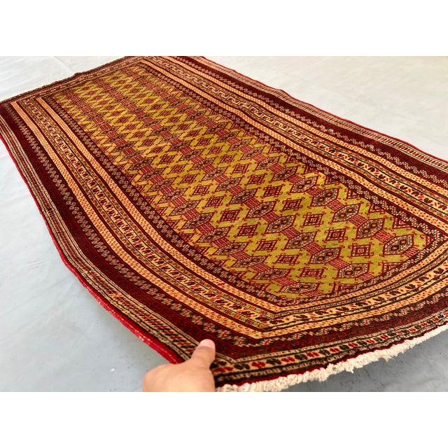 A vintage Afghan Zahir Shahi rug in the rare pistachio-green colorway — the celebrated "King's pattern" marching in...