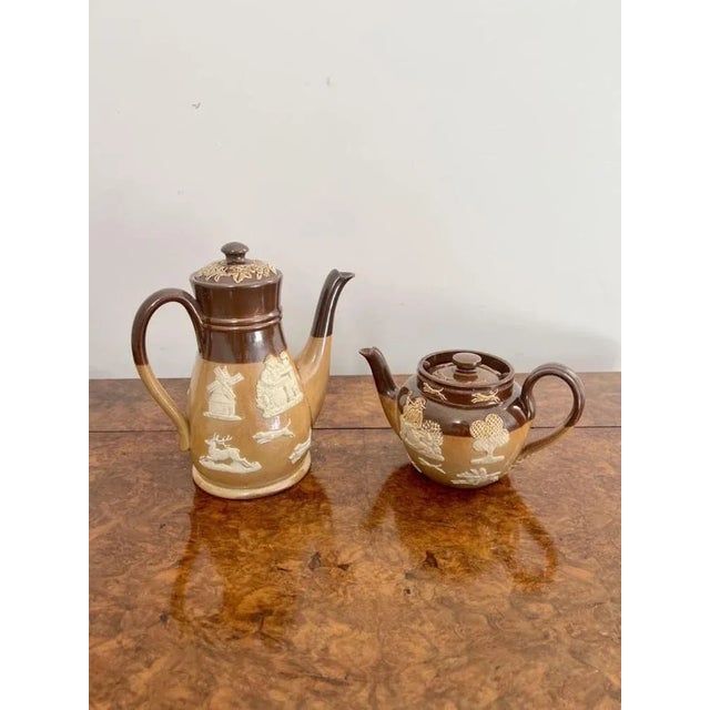 Rare antique Doulton four piece tea set, comprising of a coffee pot, tea pot, milk jug and sugar bowl decorated in hunting...