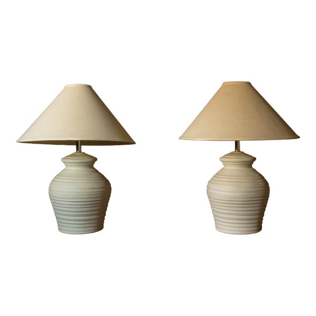 Pair of vintage sculptural ceramic pottery table lamps circa 1980's. This classic set features a textured matte finish in...