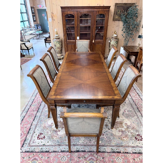 A distinguished 9-piece dining set from Ethan Allen’s celebrated Goodwin Collection, blending formal American...