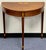 Baker Furniture American Federal-style inlaid mahogany demilune console table offers a masterful blend of classical...