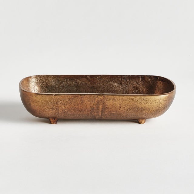 A narrow, curved form and simple design make this cast aluminum tray unique. Line with a collection of candles, or...