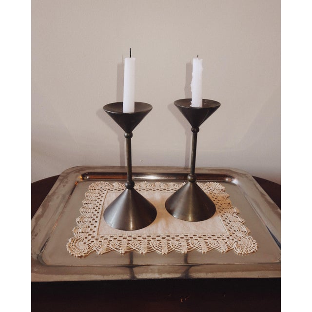 A bold, sculptural pair pulled straight from the early 1980s Memphis moment. These vintage brass candlesticks play with...