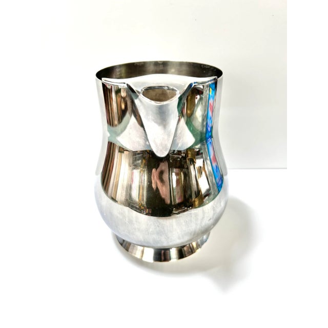 Vintage W&S Blackinton silverplate water pitcher featuring a classic mid-century silhouette, pedestal base, and polished...
