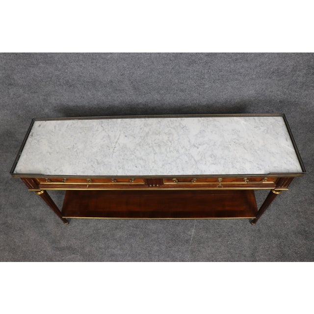 This handsome Louis XVI-style walnut console table is distinguished by its long, elegant proportions, restrained...
