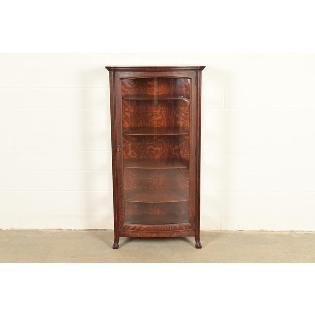 An exceptional antique Victorian, American Empire, or Arts & Crafts bookcase, dining cabinet, or display cabinet By Berkey...