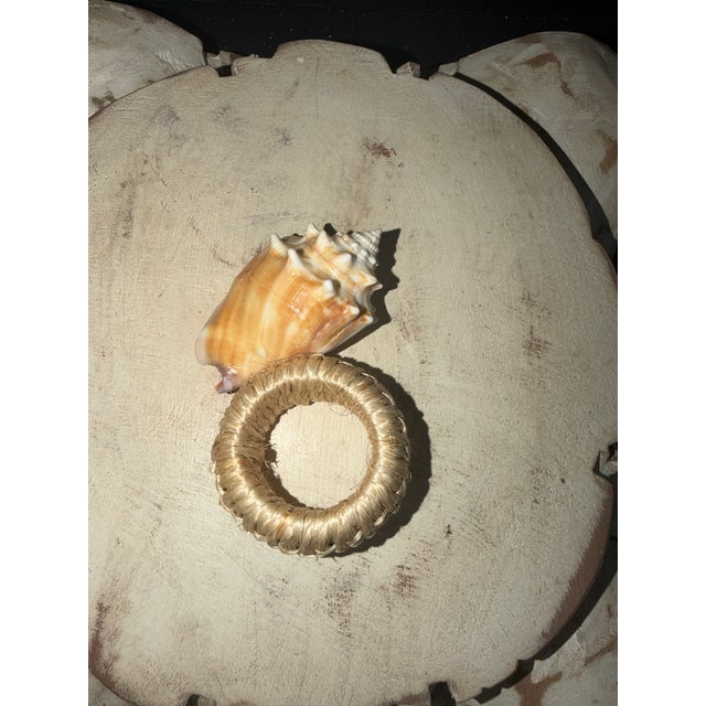 Porcelain Lenox scalloped shell bowl with 24 karat gold trim. Six Florida fighting conch napkin rings.