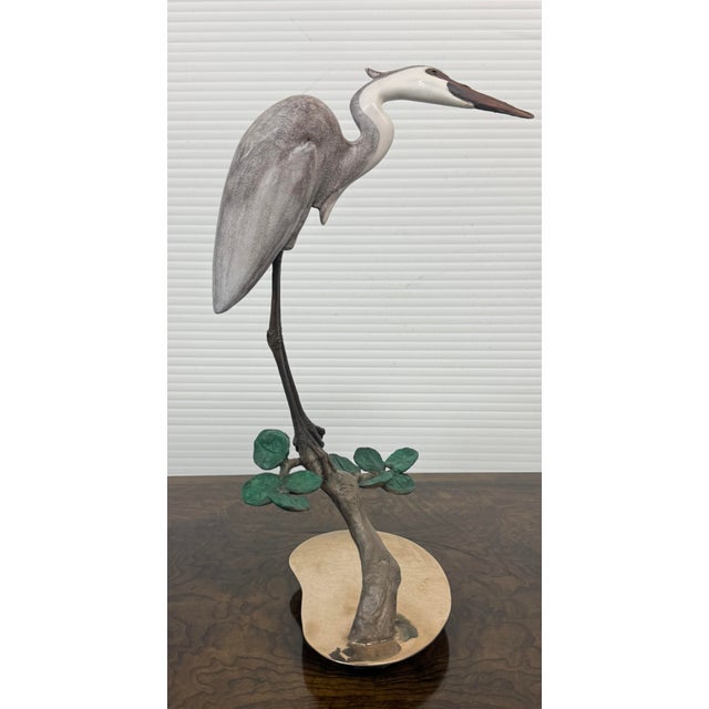 Design Plus Gallery presents Heron on a Branch with Lilies by Brian Arthur (1935-2022). This is a prominent wildlife cast-...