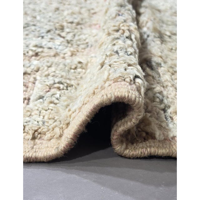 Vintage Beni Mguild Rug – Handmade Moroccan Wool Rug This beautiful vintage Beni Mguild rug features a softly faded...