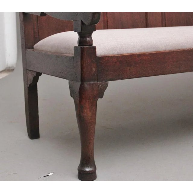 18th Century oak settle / bench the high back with five arched fielded oak panels flanked by down swept arms on turned...