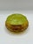 A striking vintage amber glass vanity jar with a chartreuse green molded lid. The base is made from heavy pressed glass...