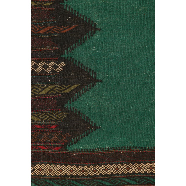 Handwoven in wool, circa 1950-1960, this 2×5 vintage Afghan tribal kilim, is a collectible tribal piece that may have been...