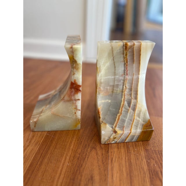 A polished set of Amber Onyx book ends.. The warm, amber, cream and brown tones are very distinct; along with the banding...