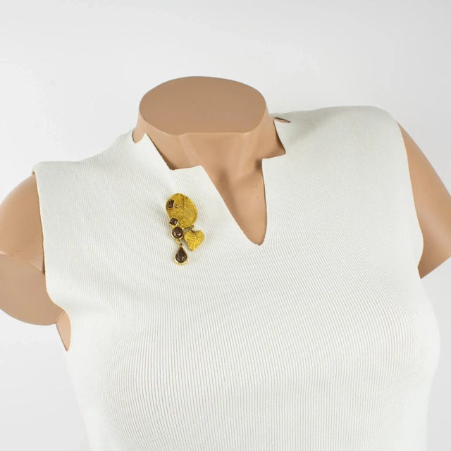 This stunning Christian Lacroix Paris signed pin brooch features a modernist shape in gilt metal all carved and textured...