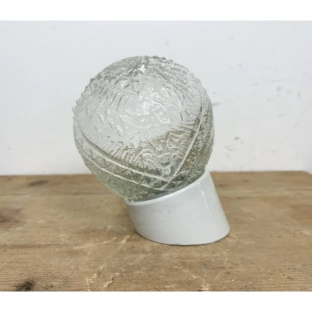 Vintage industrial light made in Poland during the 1970s.It features a white porcelain wall mounting and a glass cover....